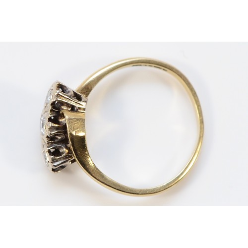 35 - A 9ct gold diamond three stone cross over ring, central diamond is brilliant cut, Sheffield 1981, I ... 