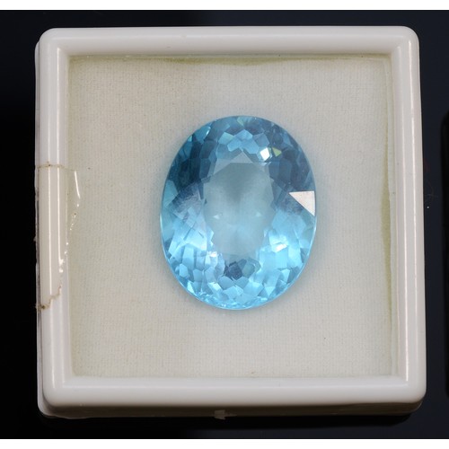 36 - An oval cut blue gemstone, probably blue topaz, measures 48.87ct on the Gemscale 125 Dendritics, 25m... 