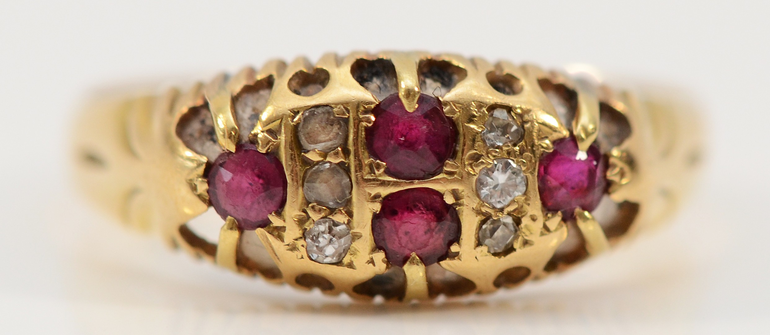 An 18ct gold Edwardian diamond and ruby boat shape ring, rose cut ...