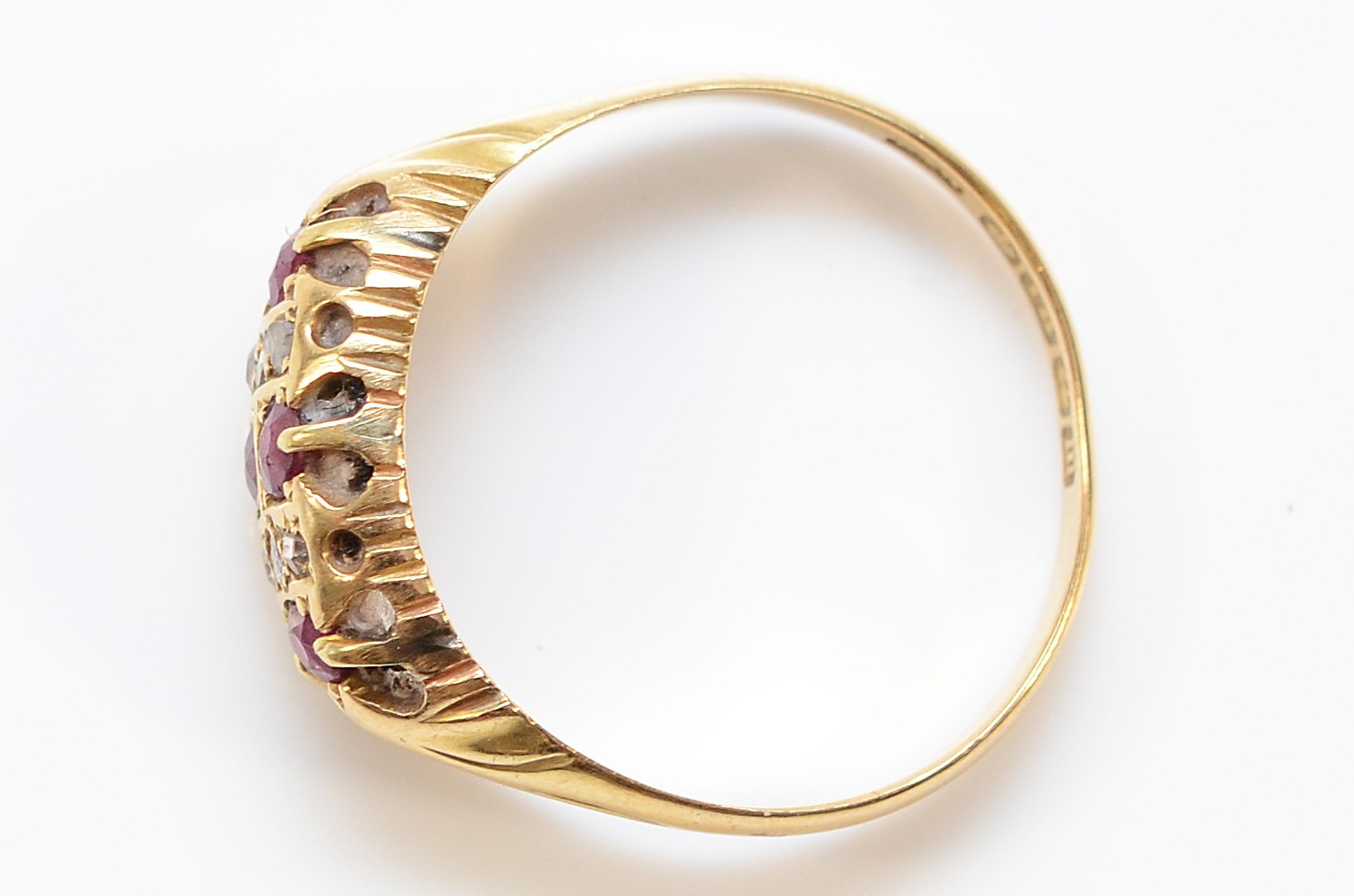 An 18ct gold Edwardian diamond and ruby boat shape ring, rose cut ...