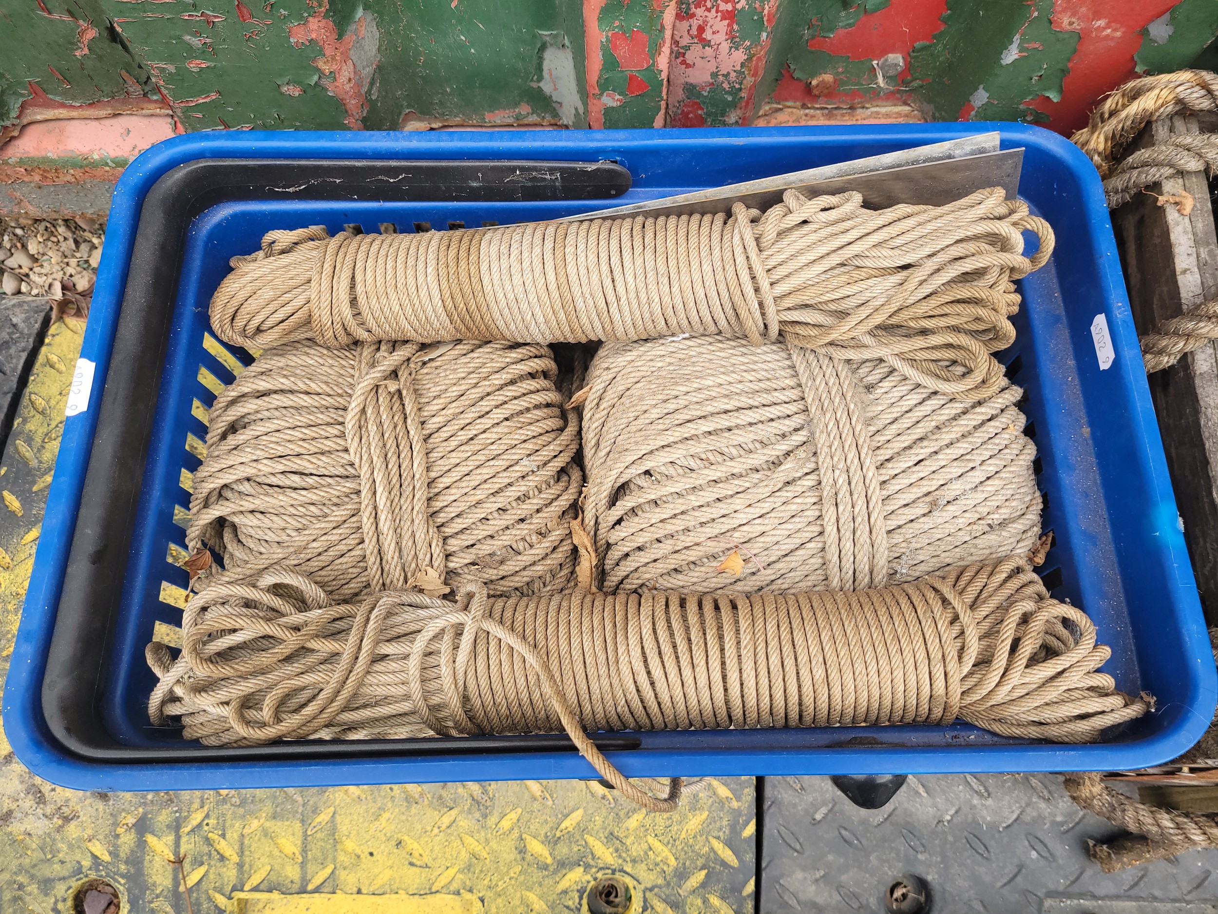 A crate of rope, together with a rate of wooden pulleys.