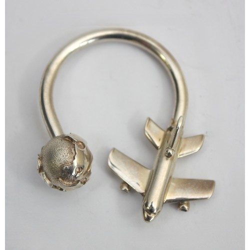 Tiffany & Co, a silver screw ball keyring decorated with a plane and globe, 4x5cm, 11gm.