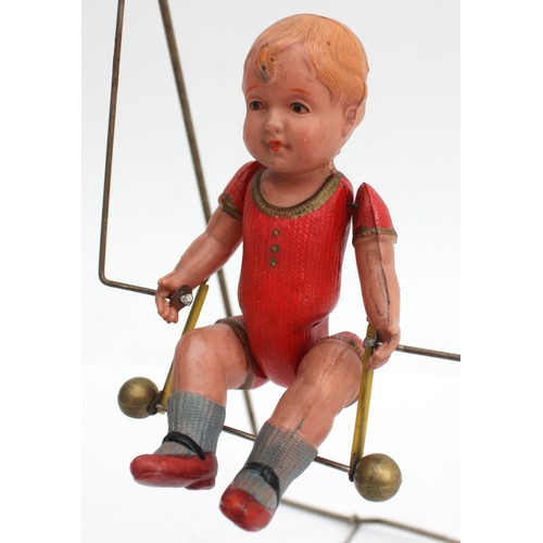 57 - Jinsey Shinan (Japan) clockwork toy model of a painted celluloid doll on a wind-up acrobatic swing m... 