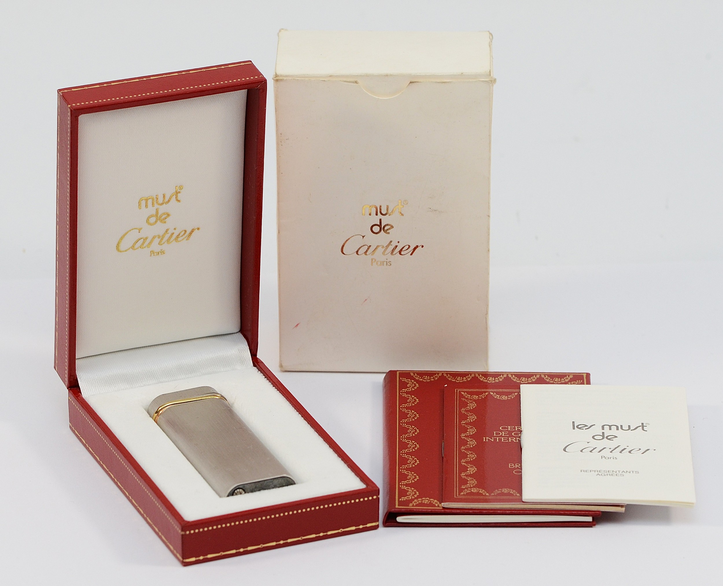 Cartier, a brushed steel lighter, with three colour band
