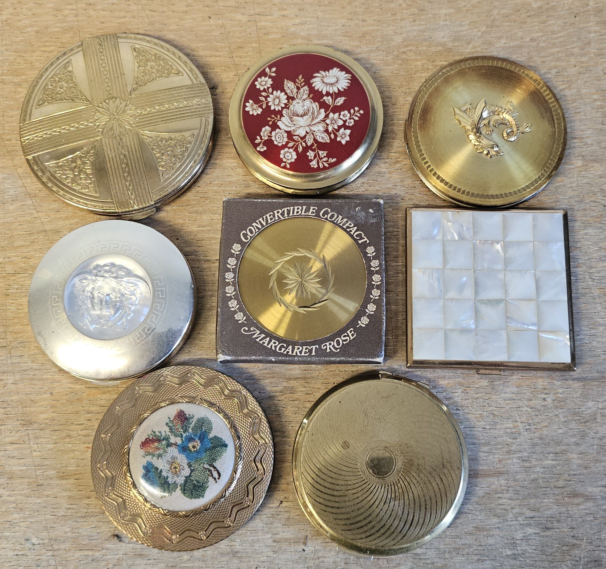 Eight various metal compacts.