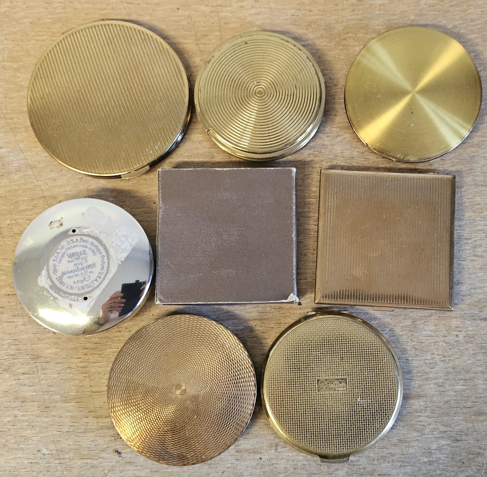 Eight various metal compacts.