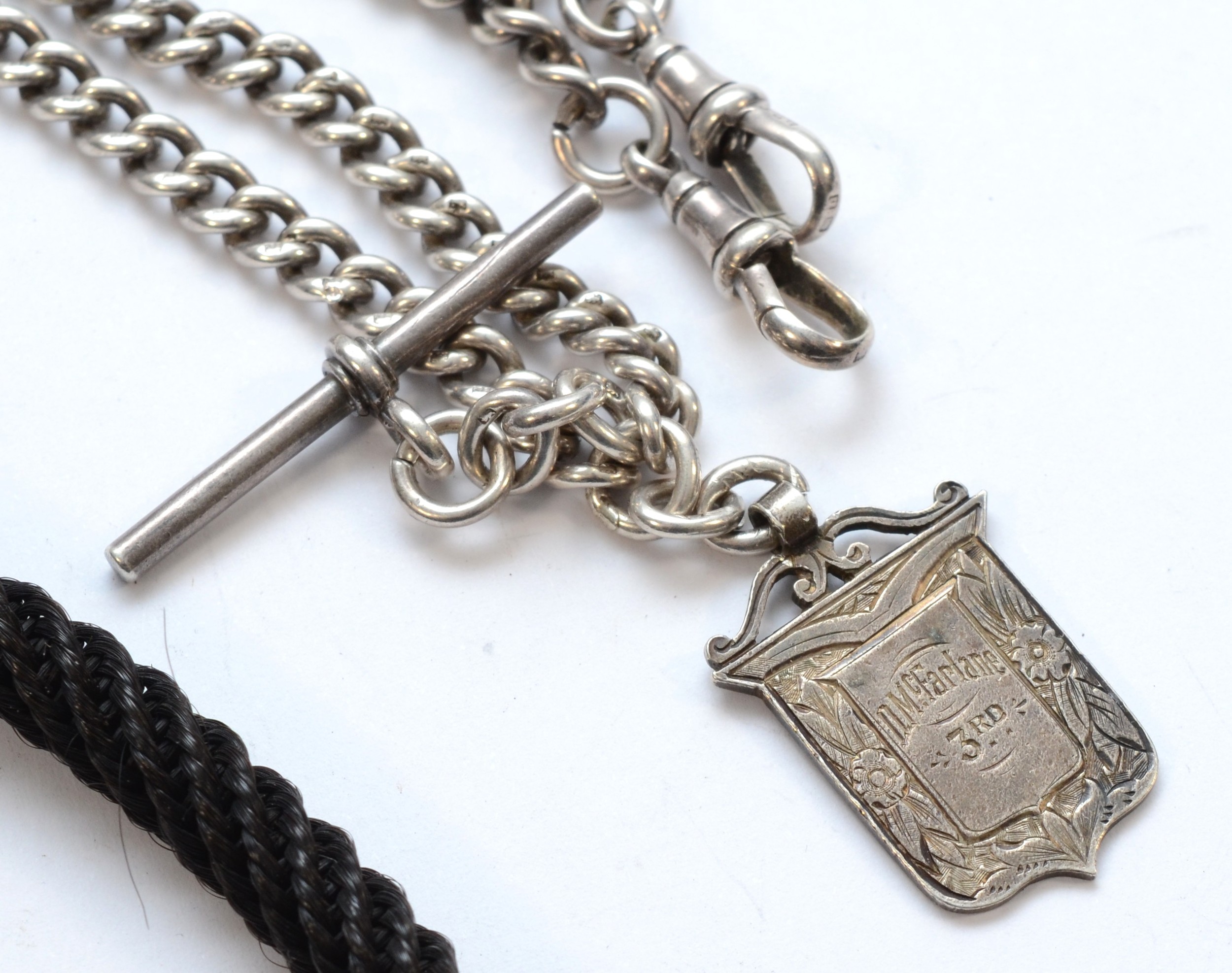 A silver watch albert, chain measuring 33cm,with fob and t bar, 40gm ...