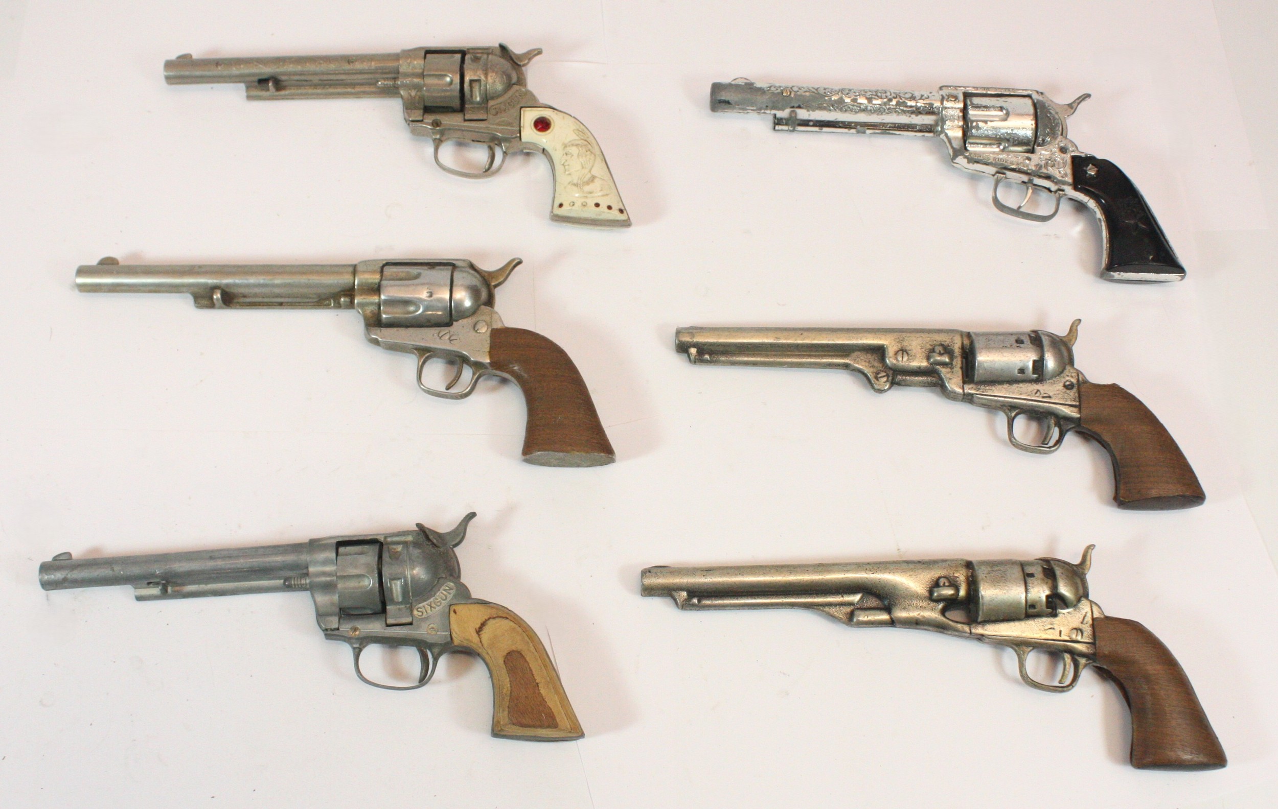 Two Sixgun toy revolvers, a Lone Star Range Rider revolver and three ...