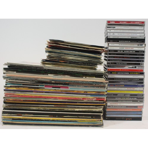 A collection of vinyl LP compilations, vinyl singles and CD's of ...