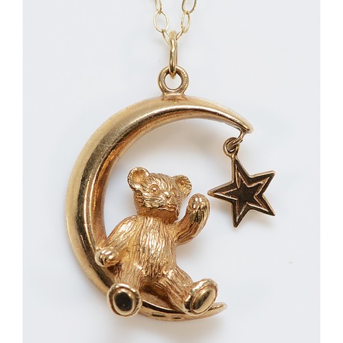A 9ct gold teddy bear sat in the moon pendant on a chain, 20mm, 2.6g