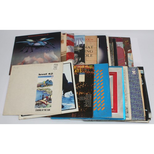 A collection of over 25 pop, rock and roll and compilation vinyl LP's ...