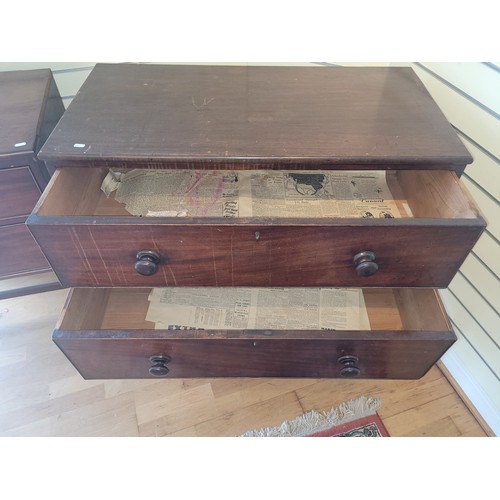 523 - A mid 20th century stained pine chest of drawers, having two long graduated drawers, on square taper... 