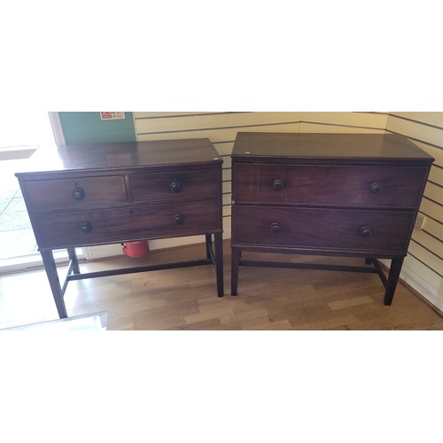 523 - A mid 20th century stained pine chest of drawers, having two long graduated drawers, on square taper... 
