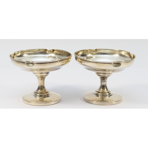 A pair of silver bon bon dishes raised on pedestals, Chester 1922, 7.5x10cm, loaded bases, having slight dints and wear to the rims of the dishes.