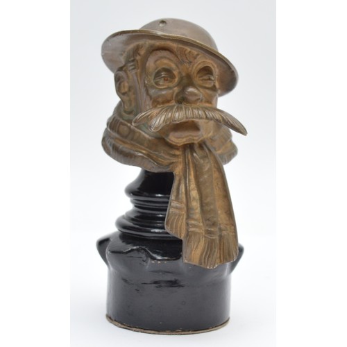 A Bruce Bairnsfather Old Bill patinated bronze car mascot, c.1920's, signed to the brim of the hat, on a later wooden stand, 14cm