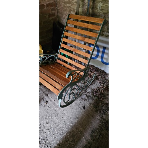 15 - A Victorian style cast iron painted garden rocking chair, early 20th century, with pivoting back sup... 