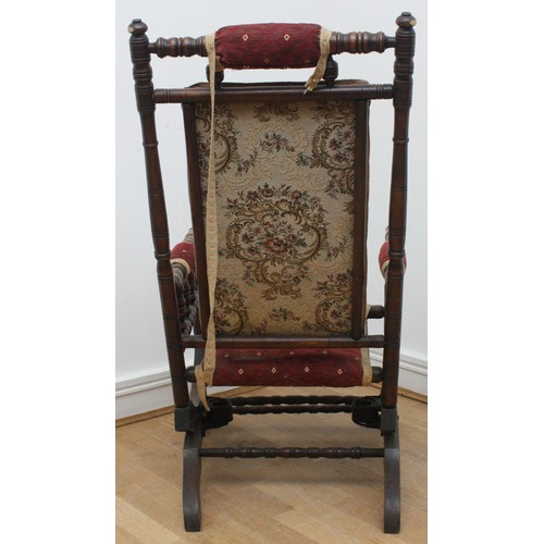 20 - An early twentieth century wooden rocking armchair, American style, with turned bobbin detail, raise... 