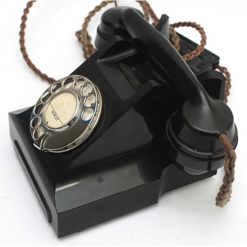 29 - A mid-twentieth century black Bakelite rotary telephone, h. 15cm x w. 18.5cm.