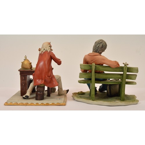 41 - Capodimonte; two figural porcelain sculptures, one depicting an unhoused individual on a park bench ... 