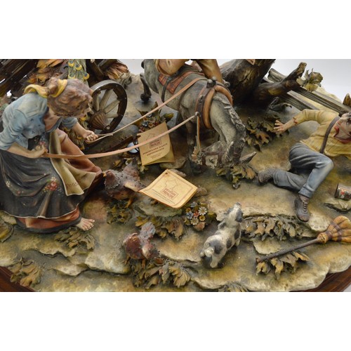 44 - Capodimonte; a large figural porcelain group depicting a peacock attacking a cart, a spooked mule, t... 