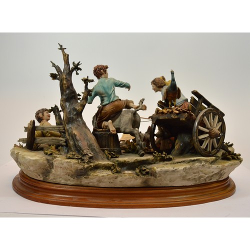 44 - Capodimonte; a large figural porcelain group depicting a peacock attacking a cart, a spooked mule, t... 