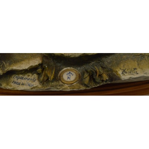 44 - Capodimonte; a large figural porcelain group depicting a peacock attacking a cart, a spooked mule, t... 