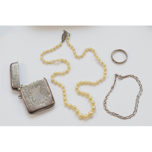 50 - A silver vesta case with striker to the bottom, Birmingham 1909, 22g, a silver clasped pearl necklac... 