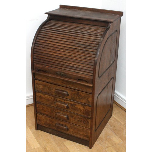 22 - An Edwardian oak roll-top desk, the tambour shutter enclosing interior with slide out writing surfac... 