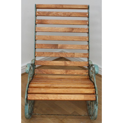 15 - A Victorian style cast iron painted garden rocking chair, early 20th century, with pivoting back sup... 