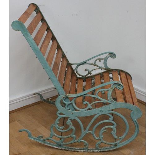 15 - A Victorian style cast iron painted garden rocking chair, early 20th century, with pivoting back sup... 