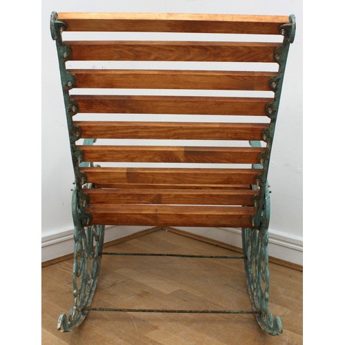 15 - A Victorian style cast iron painted garden rocking chair, early 20th century, with pivoting back sup... 