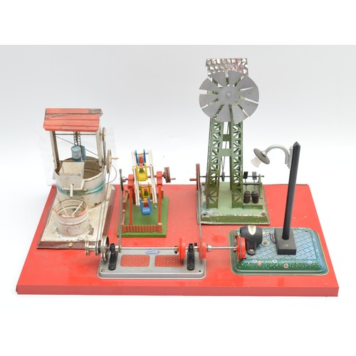 Wilesco; a composite tinplate play set featuring a wind turbine, a well, a Ferris wheel, and a street light, powered manually, 32cm x 50.5.