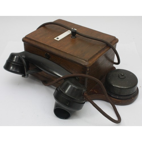 A signal box wooden cased wall telephone and a black Bakelite internal ...