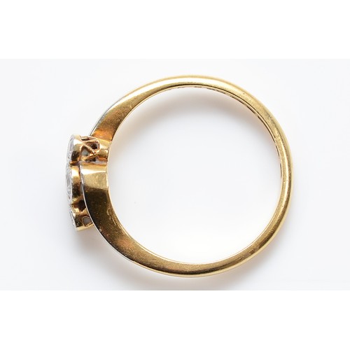 29 - An 18ct and platinum brilliant cut diamond three stone cross over ring, M, 2.6g