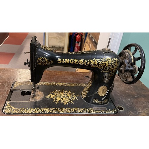 22 - Three early 20th century Jones and Singer treadle sewing machines, oak cased on cast iron frames, la... 