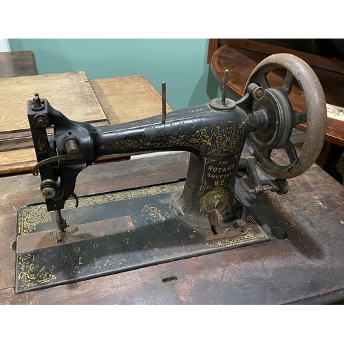 22 - Three early 20th century Jones and Singer treadle sewing machines, oak cased on cast iron frames, la... 