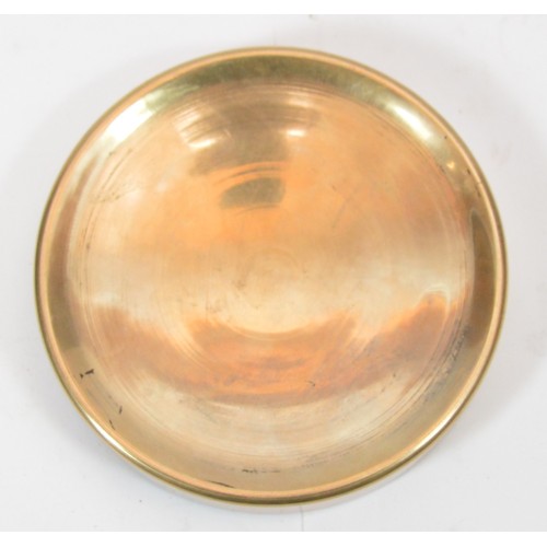 42 - A brass medallion featuring a kneeling female form in high relief with a city scape in the backgroun... 