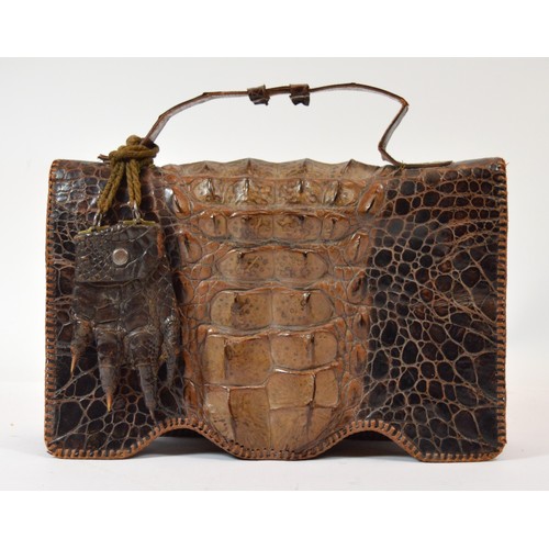 61 - An alligator taxidermy handbag featuring five internal pockets, one with zipper, snap popper closure... 