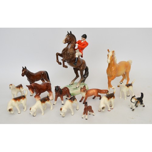 Nine Beswick models of animals, to include, a Prancing Arab Palamino horse, together with four unbranded models, and a model of a Huntsman on Rearing House, similar to Beswick model no. 868. (14)