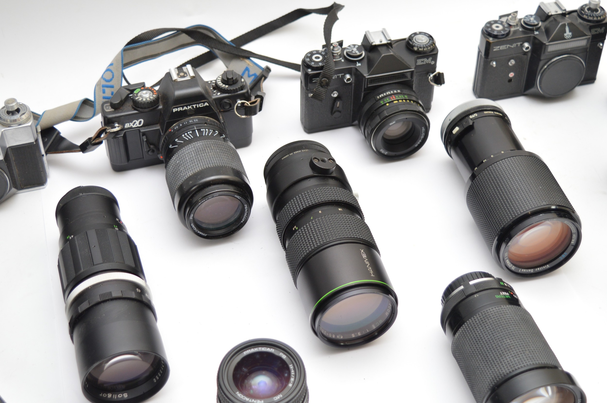 An assortment of camera lenses with two Zenit film cameras, examples to ...