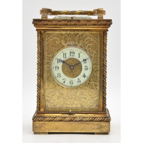 A late 19th century French brass carriage clock, white dial with Roman numerals, pierced fretwork front and side panels, twist column borders, lacking striking part of the movement  and one side glass panel, gong present, balance spins, key, 16cm.
Not working.