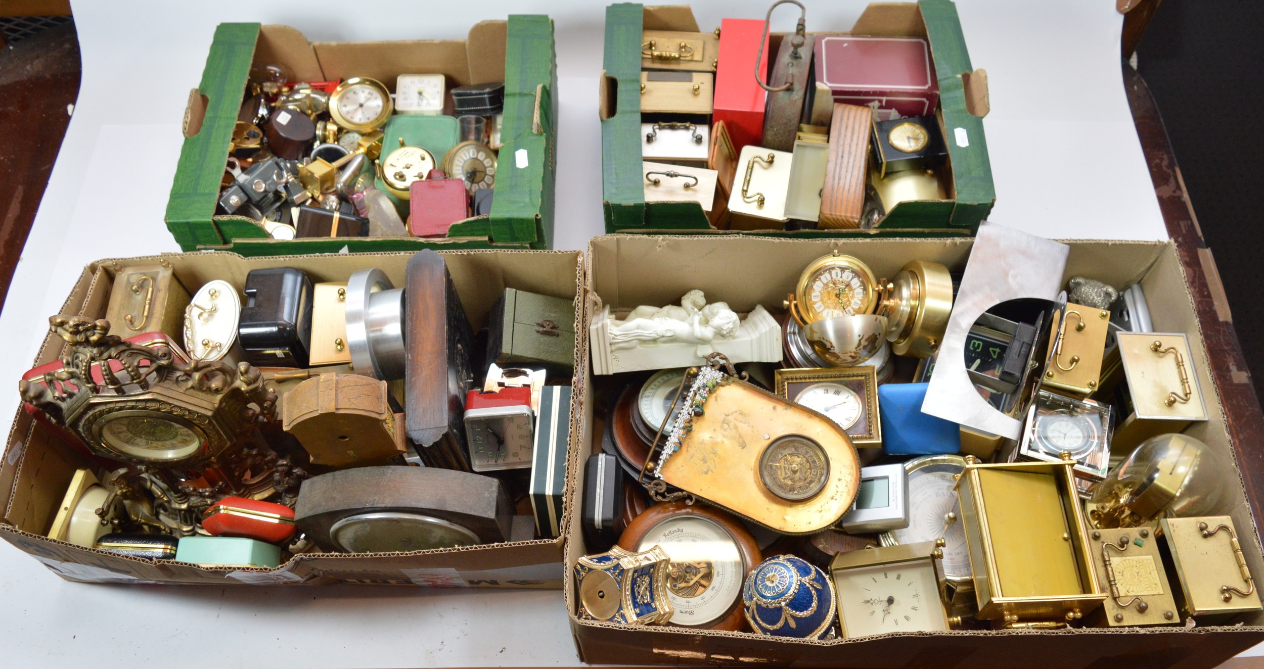 A collection of mid 20th century and later clocks in four boxes, to ...