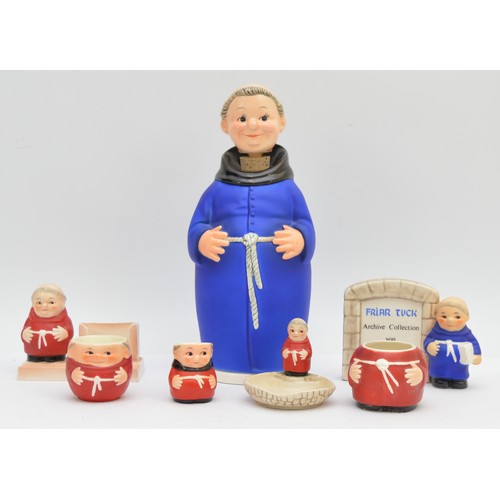 Six Goebel porcelain pieces, in the form of Monks / Friars,  depicted wearing red or blue robes, and in the form of a desk calendar, egg cup, trinket dish, and spare body, with Goebel stamp to the base, dated 1964-72, a Friar Tuck Archive Collection plaque, another egg cup, and a tall monk with a shallow stem holder contained in the base, dated 1991-present, with stamps to bases, dated 1991-present, the tallest item measuring 26cm. (7 in total with spare body)