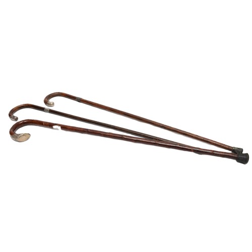9 - Three wooden crook handled walking canes, having silver band to the tops, Birmingham 1897, 1871, Lon... 