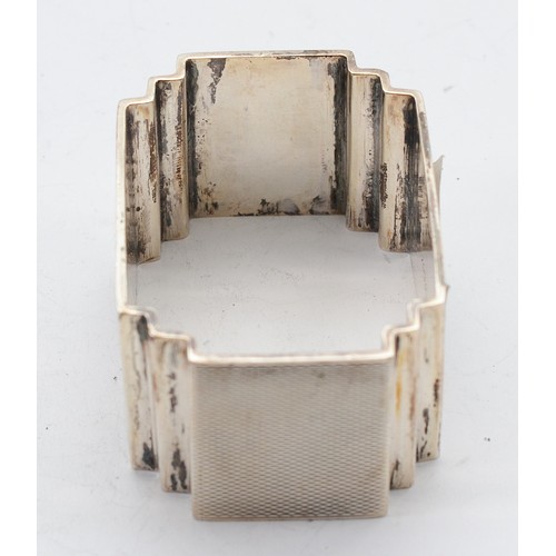 18 - An Art Deco silver napkin ring, Birmingham 1933, by Charles S Green & Co Ltd, with the initials 'VN'... 
