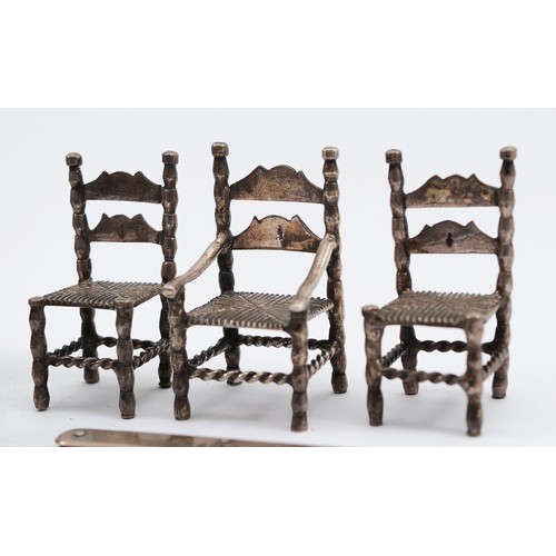 20 - Three Dutch silver miniature chairs, with Hanau markings to the bases, 5x3cm, together with a silver... 