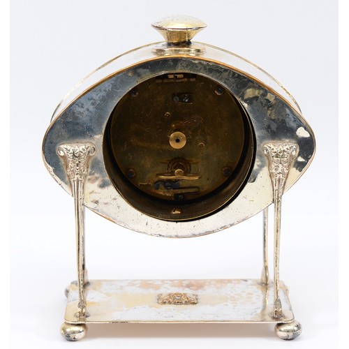 12 - An oval hammered Arts and Crafts silver plated desk clock, raised on monopedia supports with satyr h... 