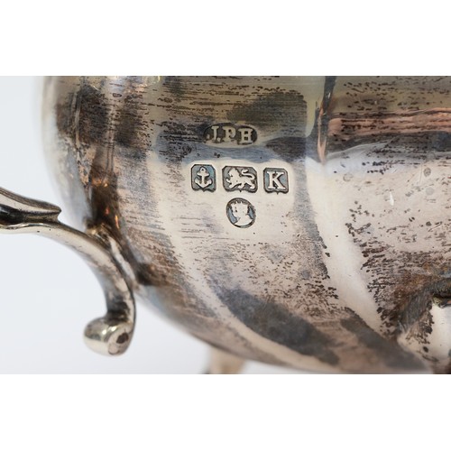 20 - A silver sugar bowl, Birmingham 1934, by  with twin handles, raised on four scroll feet, 20x10cm, to... 