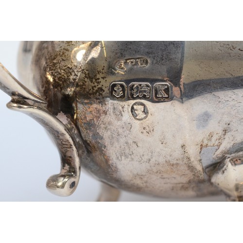 20 - A silver sugar bowl, Birmingham 1934, by  with twin handles, raised on four scroll feet, 20x10cm, to... 