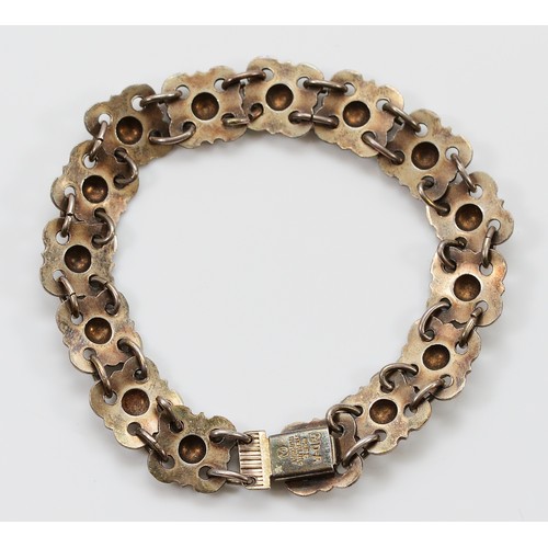 48 - Willy Winnaess for David Andersen, a 925 Norwegian silver and white enamel floral link bracelet, 18c... 